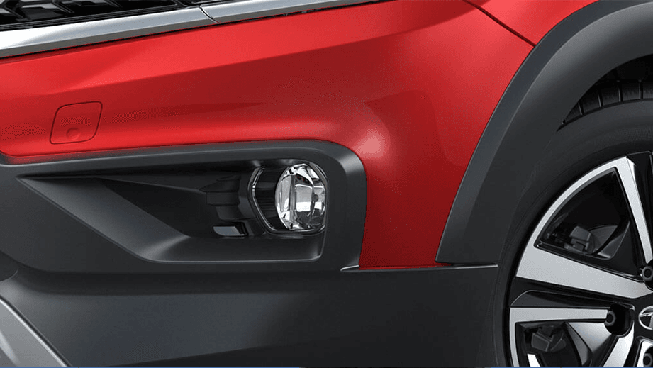 Front wheel and fog light area of a Fire Red Tata Tiago NRG