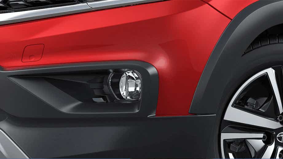 Front wheel and fog light area of a Fire Red Tata Tiago NRG