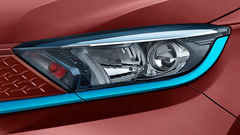 Headlight close-up of a Magnetic Red Tata Tigor EV