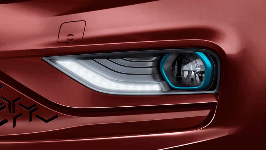 Headlight close-up of a Magnetic Red Tata Tigor EV