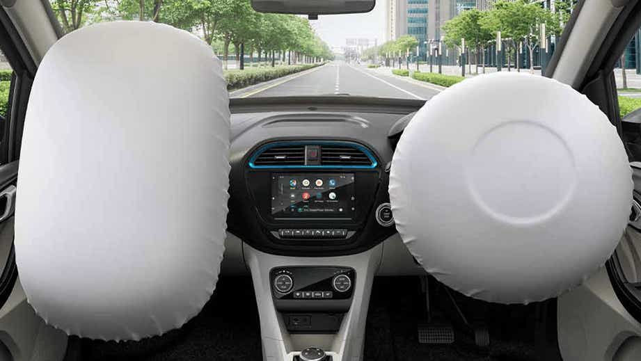 Front interior view with airbags deployed of a Tata Tigor EV