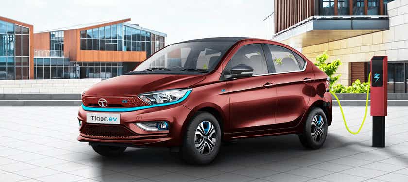 Front three-quarter view of a Magnetic Red Tata Tigor EV