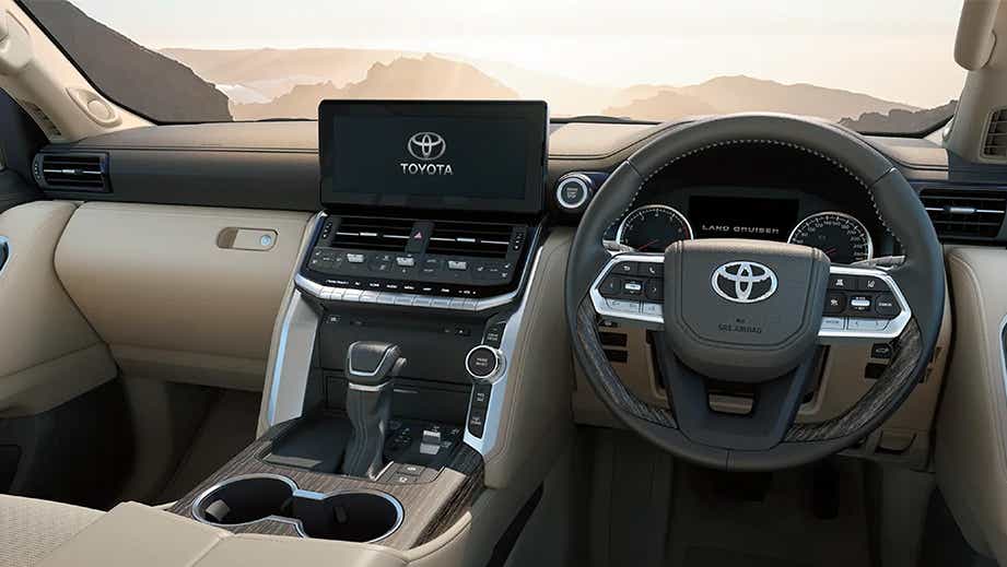 Dashboard and steering wheel of a Precious White Pearl Toyota Land Cruiser 300