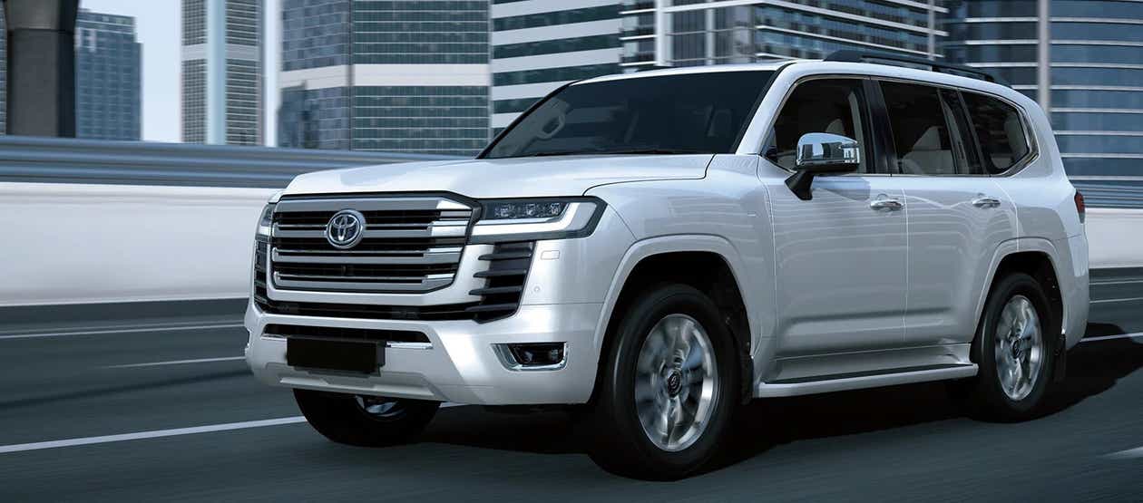 Front three-quarter view of a Precious White Pearl Toyota Land Cruiser 300