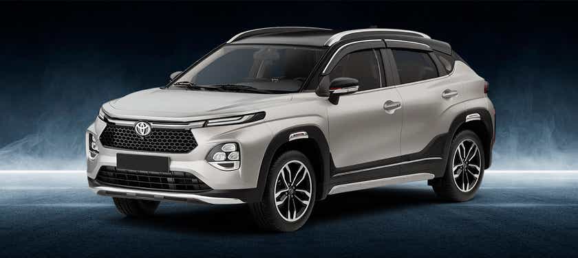 front three-quarter of a Cafe White with Midnight Black Toyota Urban Cruiser Taisor