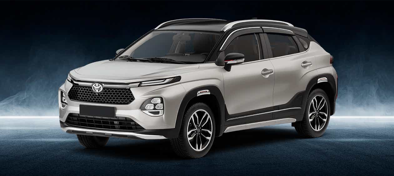 front three-quarter of a Cafe White with Midnight Black Toyota Urban Cruiser Taisor