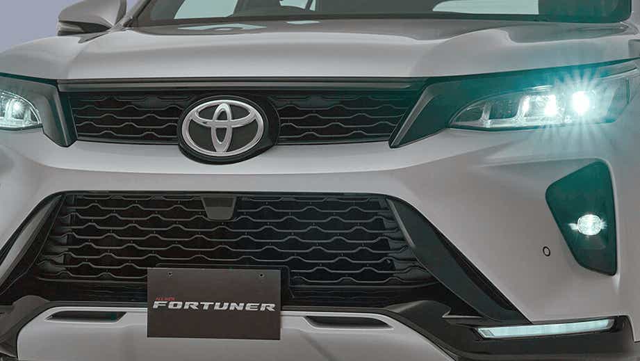 front grille and headlight view of a Platinum White Pearl Toyota Fortuner Legender