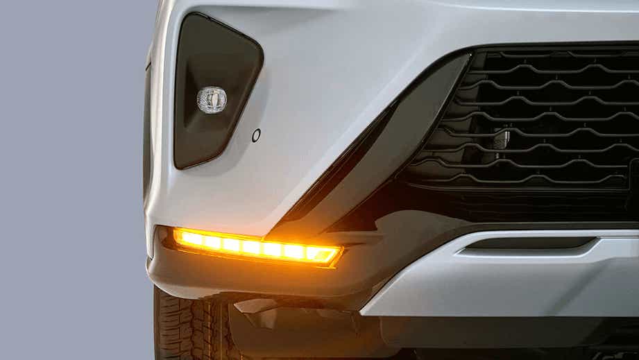front bumper and grille close-up of a Platinum White Pearl Toyota Fortuner Legender