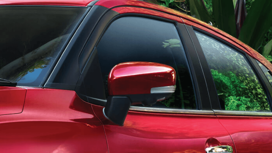 Side mirror and front door view of a Sportin Red Toyota Glanza