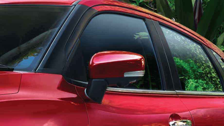 Side mirror and front door view of a Sportin Red Toyota Glanza