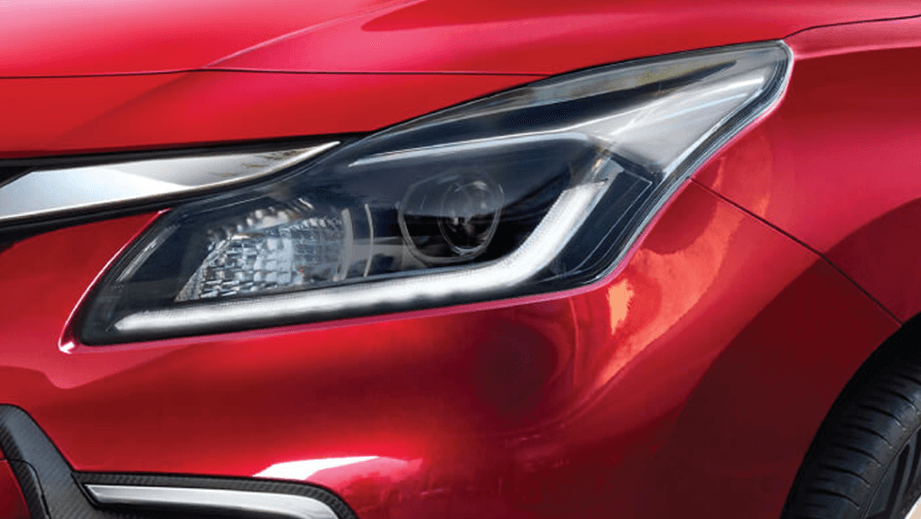 headlight close-up of a Sportin Red Toyota Glanza