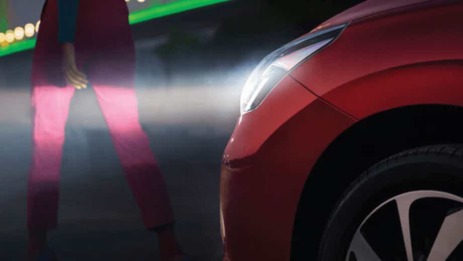 Front left headlight and fender of a Sportin Red Toyota Glanza