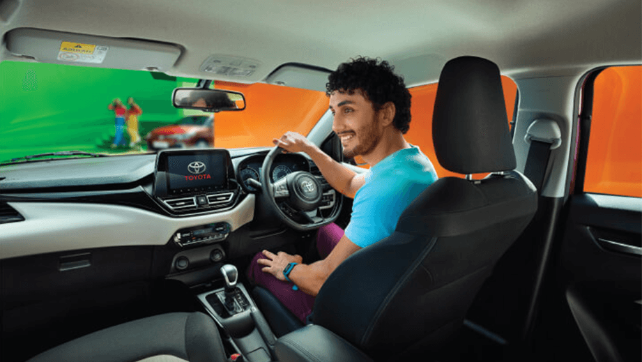 Interior front cabin of a Toyota Glanza, steering wheel and dashboard view