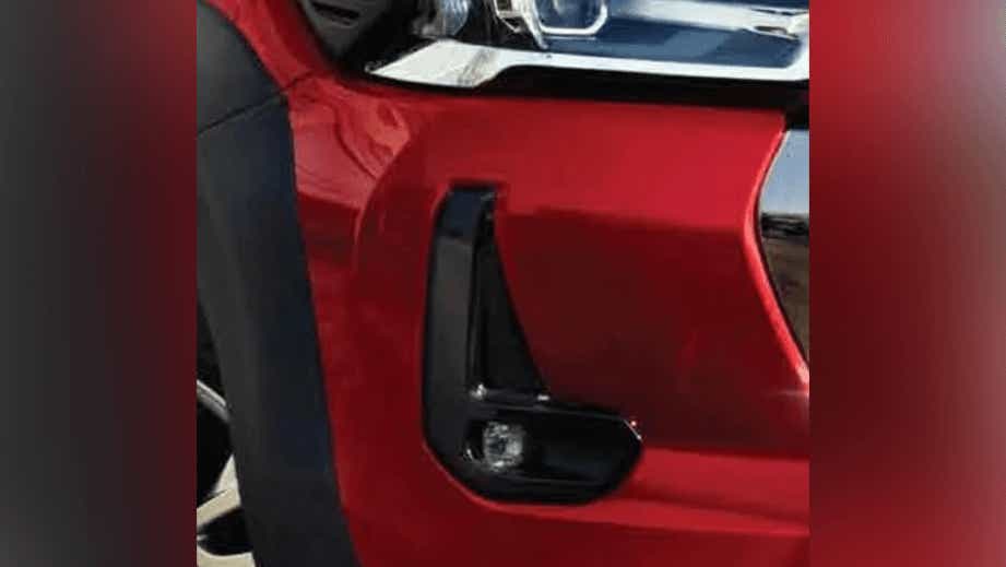 Front bumper and fog light area of a Emotional Red Toyota Hilux