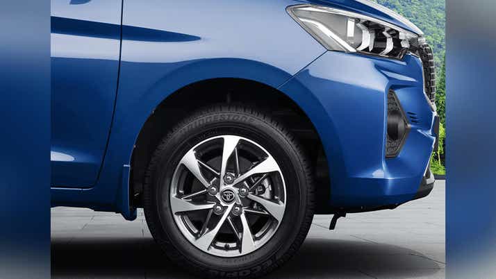 Front wheel and headlight area of a Spunky Blue Toyota Rumion