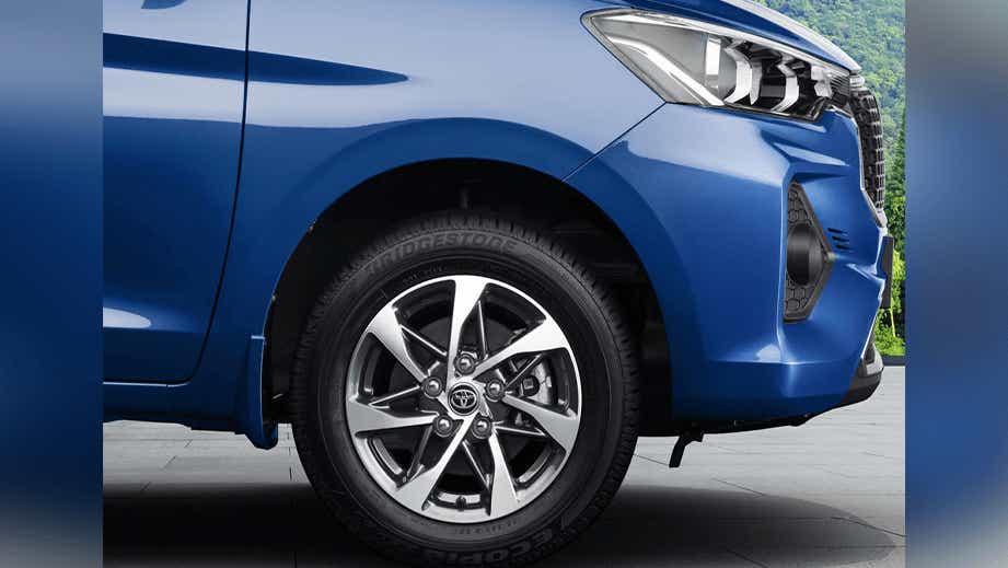 Front wheel and headlight area of a Spunky Blue Toyota Rumion