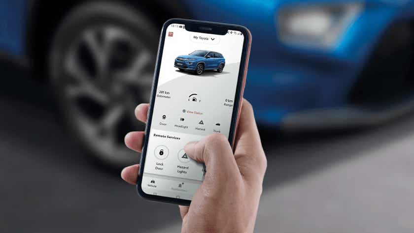 person using phone app with a Toyota Urban Cruiser Hyryder interface