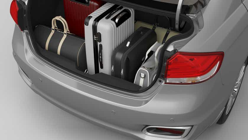 Open trunk view of a Polar White Toyota Belta loaded with luggage