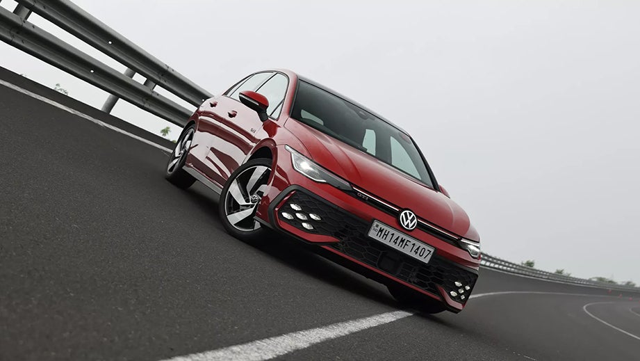 Front three-quarter view of a Kings Red Metallic Volkswagen Golf GTi