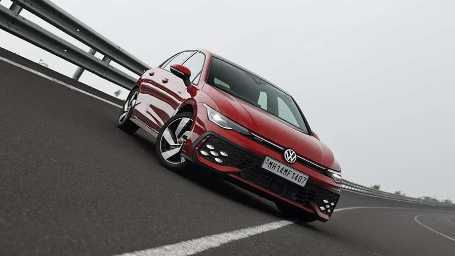 Front three-quarter view of a Kings Red Metallic Volkswagen Golf GTi