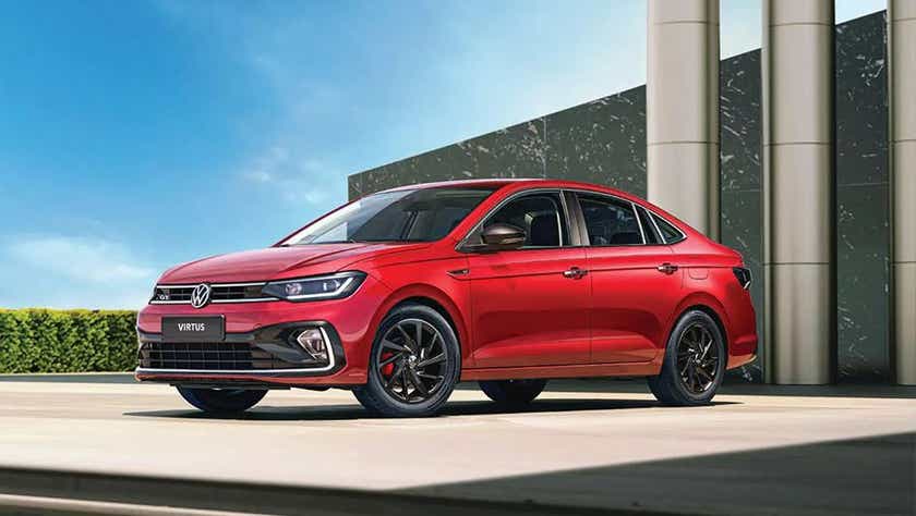 front three-quarter view of a Wild Cherry Red Volkswagen Virtus