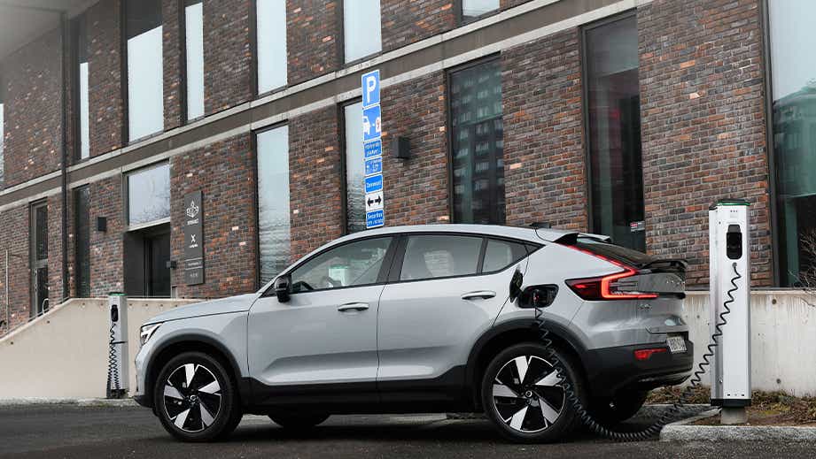 side view of a Volvo C40 Recharge charging at a station