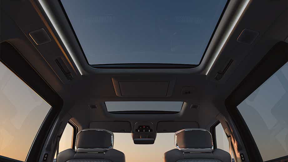 Panoramic sunroof view of a Volvo EM90 interior