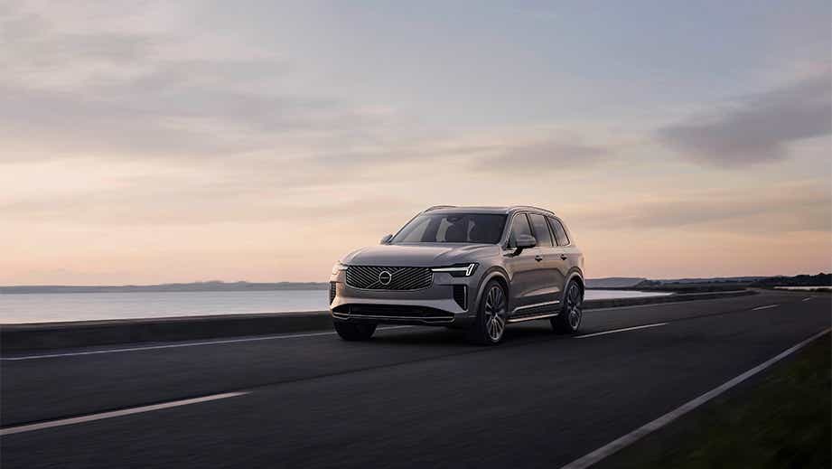 front three-quarter view of a Volvo XC90 on coastal road