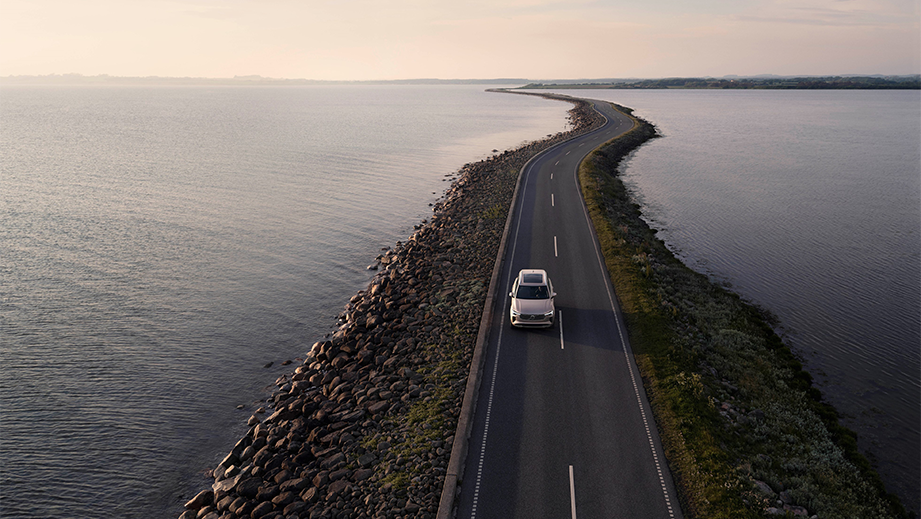 aerial view of a Volvo XC90 driving on a coastal road