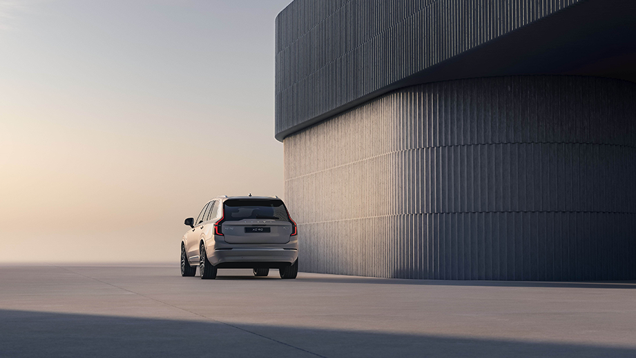 Rear view of a Volvo XC90 beside a modern building