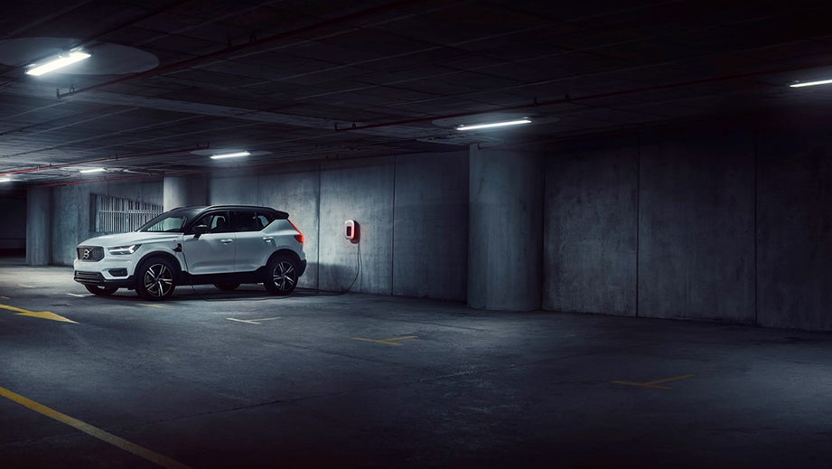 front three-quarter view of a Volvo XC40 Recharge charging in a parking garage