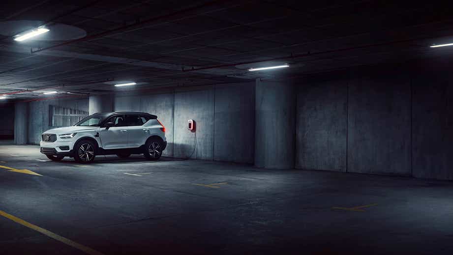front three-quarter view of a Volvo XC40 Recharge charging in a parking garage