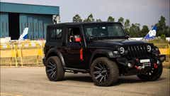 front three-quarter view of a Napoli Black Mahindra Thar