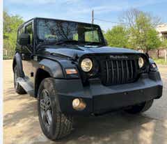 front three-quarter view of a Napoli Black Mahindra Thar