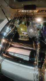 Trunk area of a Maruti Suzuki Ignis with celebration balloons and cake