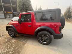 side view of a Rage Red Mahindra Thar