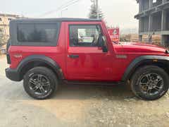side view of a Rage Red Mahindra Thar