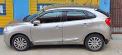 side view of a Splendid Silver Maruti Suzuki Baleno