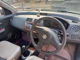 Interior dashboard view of a Maruti Suzuki Dzire Tour