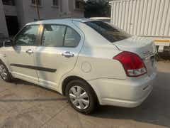 rear three-quarter of a Maruti Suzuki Dzire Tour