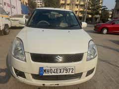 Front view of a Pearl Metallic Arctic White Maruti Suzuki Dzire Tour