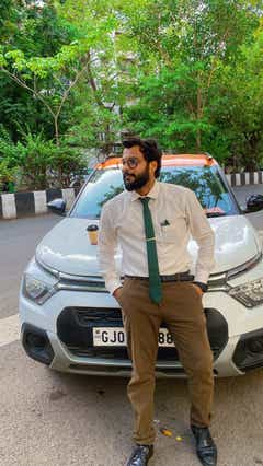 Front view of a Citroen C3 with a person leaning on the car