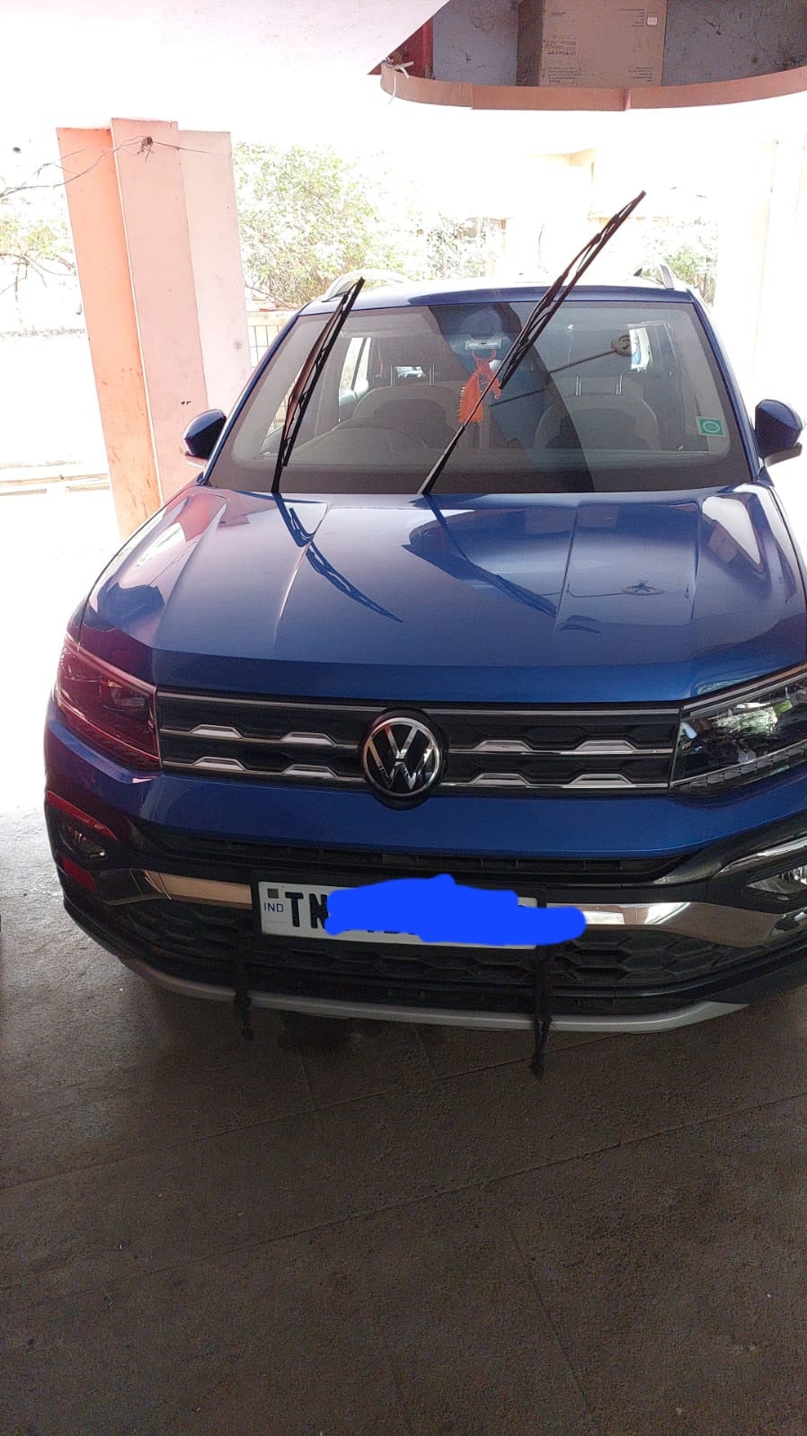 Front view of a Lava Blue Volkswagen Taigun