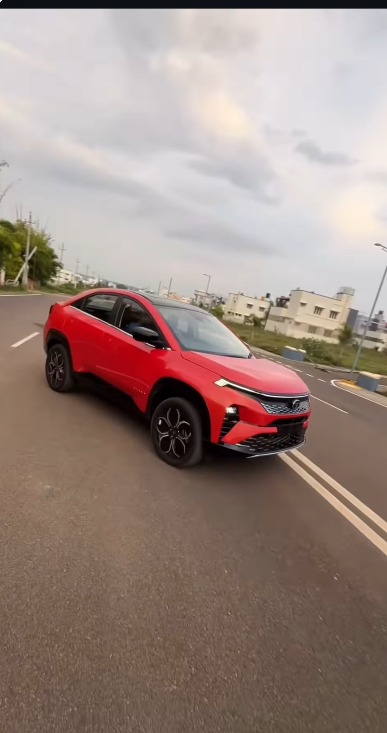 front three-quarter view of a Flame Red Tata Curvv