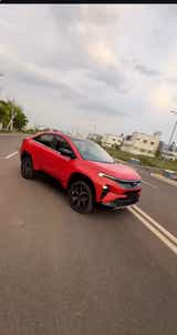 front three-quarter view of a Flame Red Tata Curvv