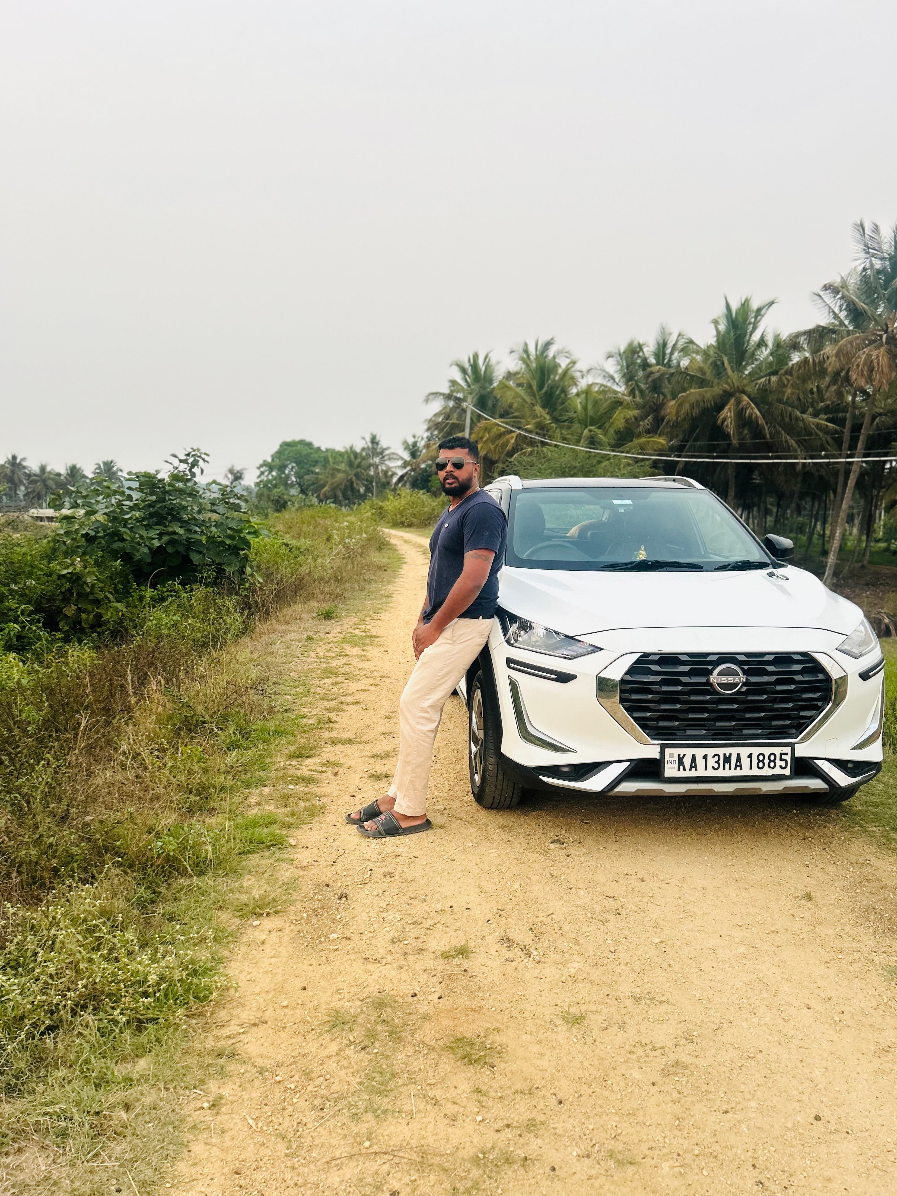 Front view of a Nissan Magnite 2020-2023 on a rural road