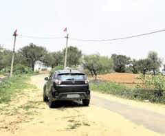 rear view of a Tata Nexon on a rural road