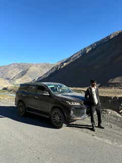 front-side view of a Toyota Fortuner on a mountain road