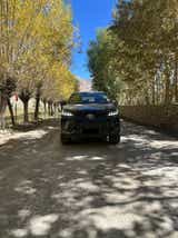 Front view of a Toyota Fortuner on a tree-lined road