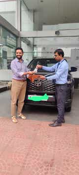 Front view of a Toyota Innova Hycross at a dealership